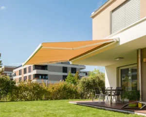 Retractable awning providing shade over lawn