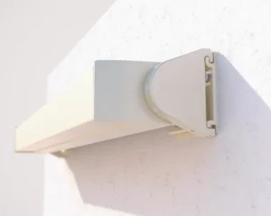 Compact awning housing installed on exterior wall