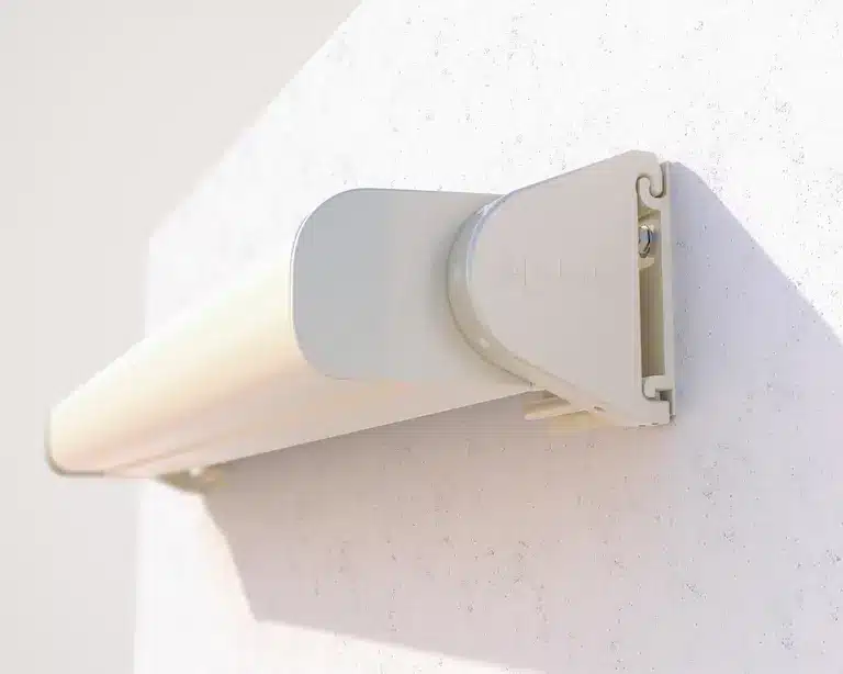 Wall-mounted awning cassette with rounded end cap