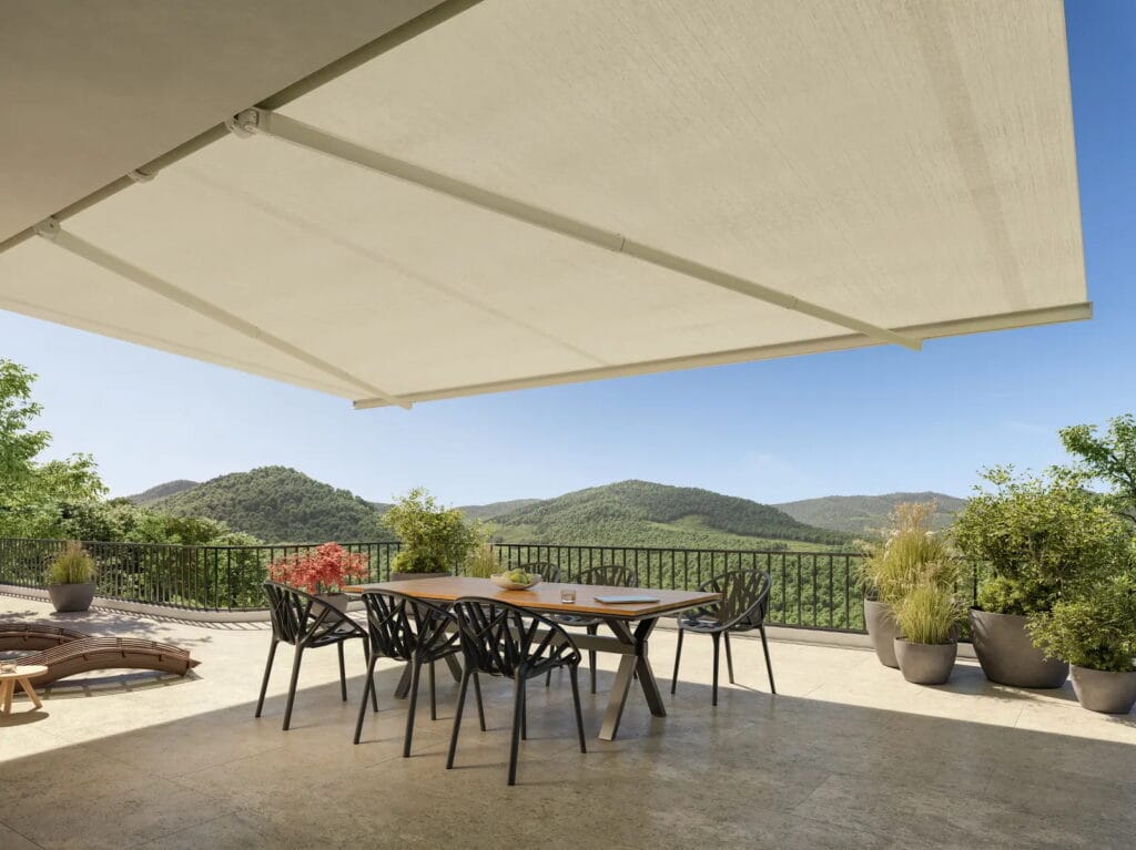 Retractable fabric shade extended over an outdoor dining area