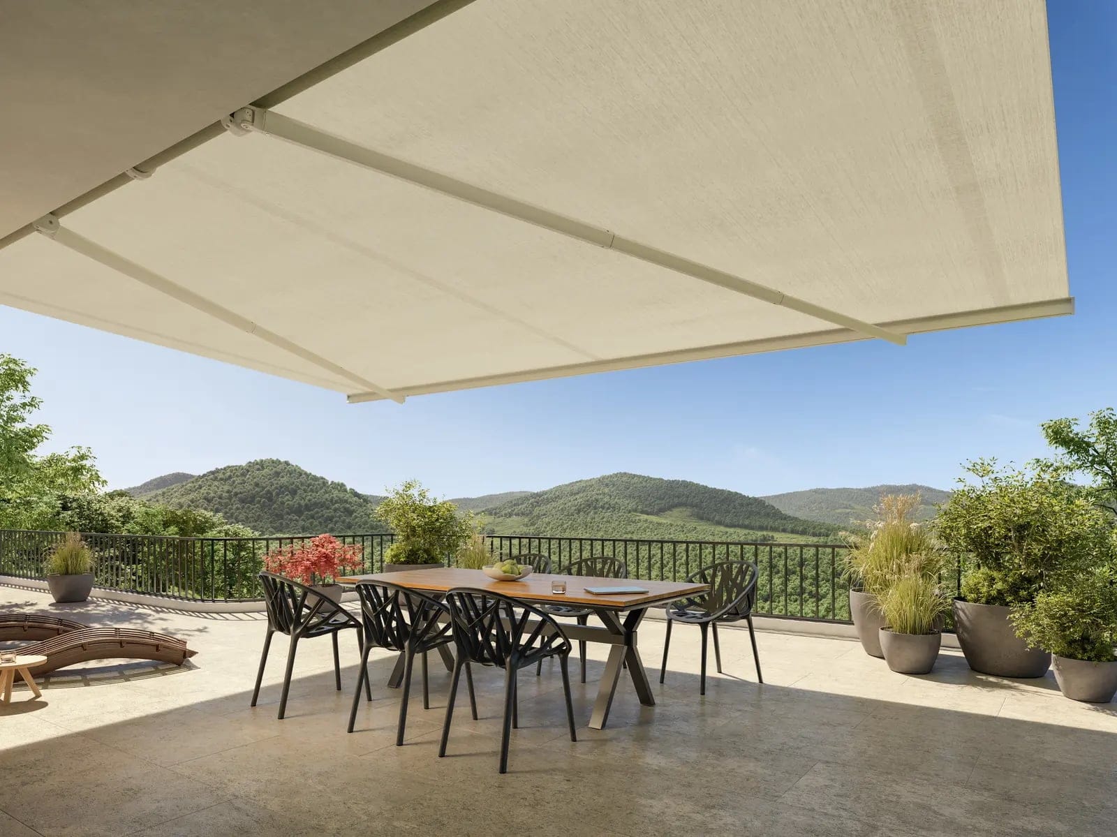 Retractable fabric shade extended over an outdoor dining area