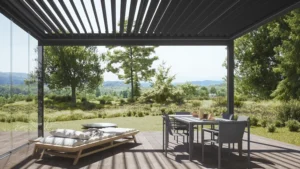 Hardtop pergola with slatted roof overlooking a landscaped yard