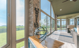 Four-season sunroom interior with floor-to-ceiling glass walls