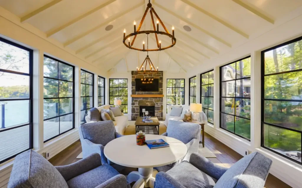 sunroom with central dining area and decorative chandelier