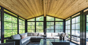 Wood-ceiling sunroom with black-framed windows and seating