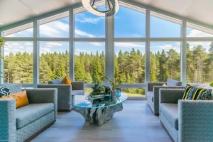 Panoramic sunroom with forest views and relaxation space