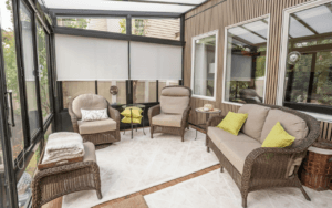 Light-filled four-season room with armchairs and large windows