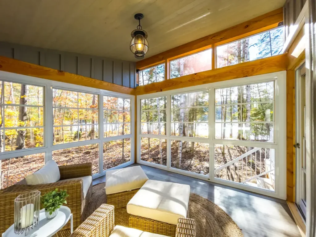 Three-season sunroom with wood ceiling and panoramic windows